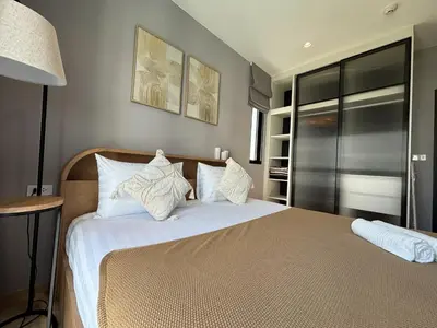 a bedroom with a bed with white sheets and pillows at The Legendary Bang Tao 2-bedrooms apart #403 in Laguna Phuket