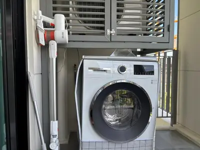 a washing machine in a room with a fan at The Legendary Bang Tao 2-bedrooms apart #403 in Laguna Phuket