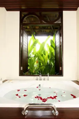 a bathroom sink with red flowers on it at The Vijitt - Deluxe Villa in Ban Saiyuan (1)