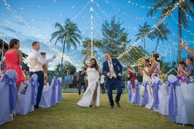 a bride and groom walking down the aisle at their wedding at The Vijitt - Deluxe Villa in Ban Saiyuan (1)