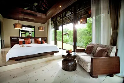 a bedroom with a large bed and a couch at The Vijitt - Deluxe Villa in Ban Saiyuan (1)