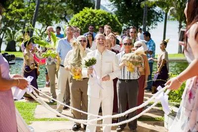 a bride and groom are cutting the ribbon at The Vijitt Resort - Deluxe Beachfront Villa in Ban Saiyuan (1)