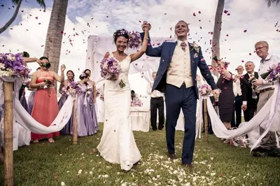 a bride and groom walking down the aisle at their wedding at The Vijitt Resort - Deluxe Beachfront Villa in Ban Saiyuan (1)