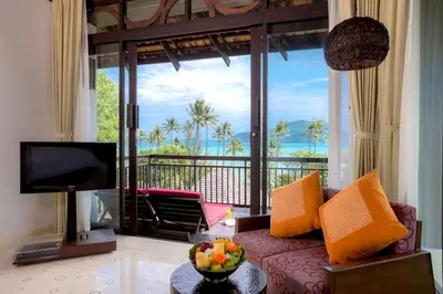 a living room with a couch and a view of the ocean at The Vijitt - Deluxe Seaview Villa in Ban Saiyuan (1)