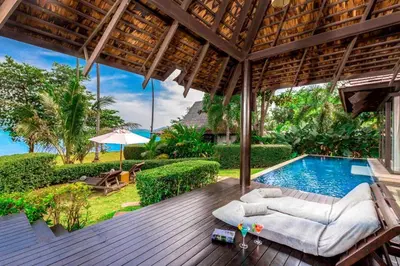 an outdoor patio with a swimming pool and a deck at The Vijitt Resort - Vijitt Pool Villa in Ban Saiyuan (1)