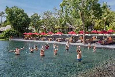 a group of people doing yoga in the water at a resort at The Vijitt Resort - Vijitt Pool Villa in Ban Saiyuan (1)