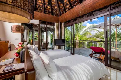 a bedroom with a large bed and a balcony at The Vijitt - Two Bedroom Pool Villa in Ban Saiyuan (1)