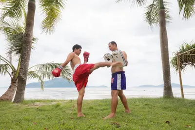 a group of three men standing on the beach at The Vijitt - Two Bedroom Pool Villa in Ban Saiyuan (1)