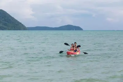 two people riding on a kayak in the water at The Vijitt - Two Bedroom Pool Villa in Ban Saiyuan (1)