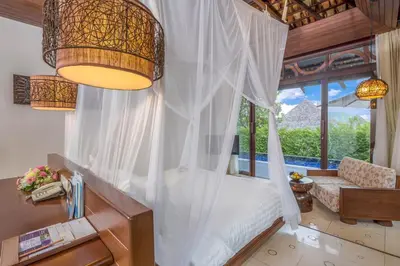 a bedroom with a bed and a large window at The Vijitt - Deluxe Pool Villa in Ban Saiyuan (1)