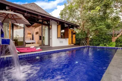 a swimming pool in front of a house at The Vijitt - Deluxe Pool Villa in Ban Saiyuan (1)