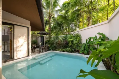 a swimming pool in the backyard of a house at Dewa Villa in Nai Yang Beach