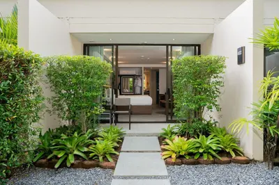 a courtyard in a house with plants at Dewa Phuket - Deluxe Garden in Nai Yang Beach