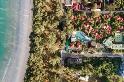 an overhead view of a resort with trees and a road at Dewa Phuket - Deluxe Garden in Nai Yang Beach