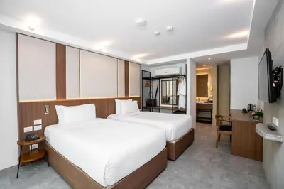 a hotel room with two beds and a kitchen at Dewa Phuket - Deluxe Garden in Nai Yang Beach