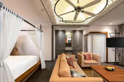a bedroom with a bed and a ceiling fan at Naiyang Villa in Nai Yang Beach