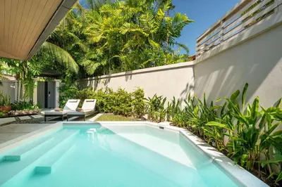 a swimming pool in the backyard of a house at Naiyang Villa in Nai Yang Beach