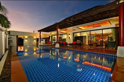 a swimming pool in the middle of a house at Kamala Private Bliss Retreat 4 Bedrooms Villa in Kamala Beach