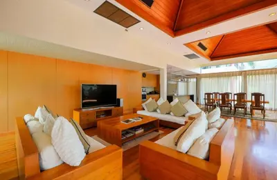 a living room with couches and a flat screen tv at Kamala Private Bliss Retreat 4 Bedrooms Villa in Kamala Beach