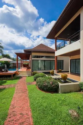 a house with a brick pathway in front of it at Kamala Private Bliss Retreat 4 Bedrooms Villa in Kamala Beach
