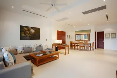a living room with a couch and a table at Sea View Pool Villa Grand Kamala Falls in Kamala Beach