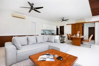 a living room with a couch and a table at 2 Bedroom Villa Janine with Private Pool and Rooftop terrace in Kamala Beach