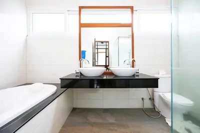 a bathroom with two sinks on a counter with a bathtub at 2 Bedroom Villa Janine with Private Pool and Rooftop terrace in Kamala Beach