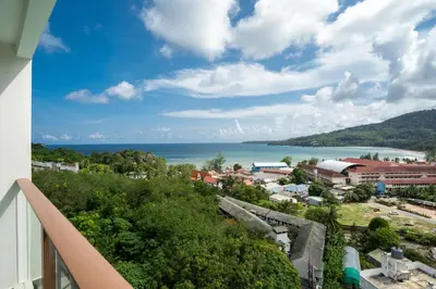 a view from a balcony of a town and the ocean at Elegant 2BR Oceanview Condo Oceana C73 - 5 min walk Kamala Beach in Kamala Beach