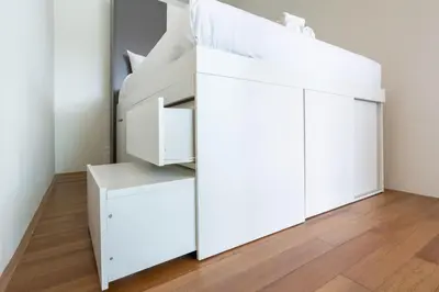 a bedroom with a white bunk bed with drawers at Elegant 2BR Oceanview Condo Oceana C73 - 5 min walk Kamala Beach in Kamala Beach