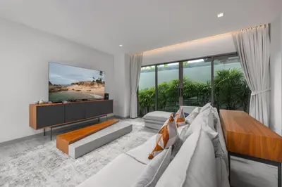 a living room with a large bed and a television at Villa Mauri – Modern 3BR Villa with Private Pool in Kata Beach