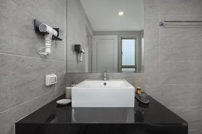 a bathroom with a white sink and a mirror at Villa Mauri – Modern 3BR Villa with Private Pool in Kata Beach