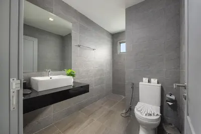 a bathroom with a white toilet and a sink at Villa Mauri – Modern 3BR Villa with Private Pool in Kata Beach