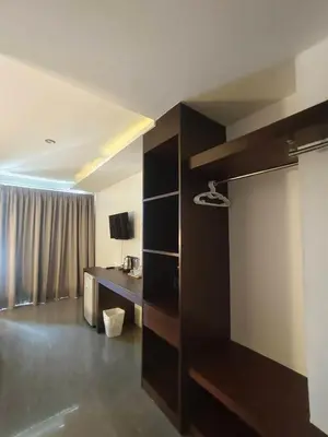 a living room with a desk and a room at Doze Bangla in Patong Beach