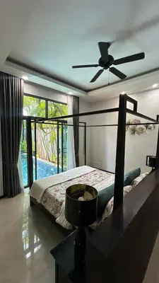 a bedroom with a bed and a ceiling fan at Cozy villa - perfect place to stay in Phuket in Ban Saiyuan (1)