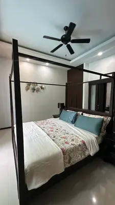 a bedroom with a bed with a ceiling fan at Cozy villa - perfect place to stay in Phuket in Ban Saiyuan (1)