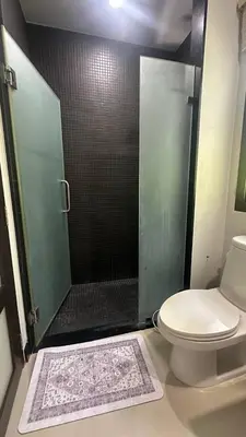 a bathroom with a shower with a toilet and a sink at Cozy villa - perfect place to stay in Phuket in Ban Saiyuan (1)
