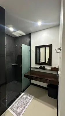 a bathroom with a mirror and a sink and a shower at Cozy villa - perfect place to stay in Phuket in Ban Saiyuan (1)