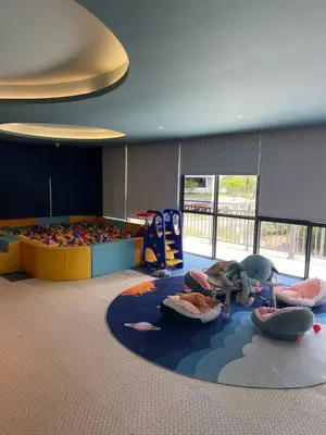 a childrens room with a play area and a playground at Kora Beach Studio in Layan Beach