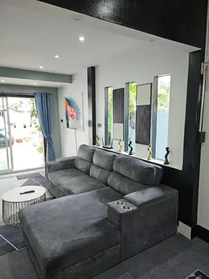 a living room with a couch and a table at Beautiful New 3 Bed 3 Bathroom Villa 400m to Bang Tao Beach Sleeps 9 in Ban Thalat Choeng Thale