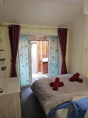 a bedroom with a large bed with red pillows on it at Beautiful New 3 Bed 3 Bathroom Villa 400m to Bang Tao Beach Sleeps 9 in Ban Thalat Choeng Thale