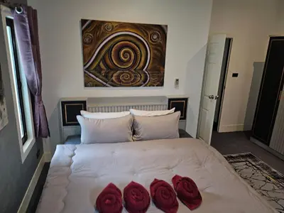 a bedroom with a bed with three roses on it at Beautiful New 3 Bed 3 Bathroom Villa 400m to Bang Tao Beach Sleeps 9 in Ban Thalat Choeng Thale