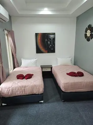 a room with two beds with red pillows on them at Beautiful New 3 Bed 3 Bathroom Villa 400m to Bang Tao Beach Sleeps 9 in Ban Thalat Choeng Thale