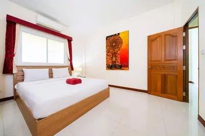 a bedroom with a bed and a window and a door at Mediteranean style 3 BR Pool Villa Platinum with garden in Rawai Beach