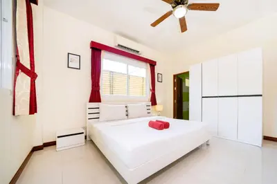 a bedroom with a white bed and a ceiling fan at Mediteranean style 3 BR Pool Villa Platinum with garden in Rawai Beach