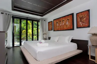 a bedroom with a large white bed and a window at 5 BR Villa Kalim 5 Private Pool with Seaview in Patong Beach