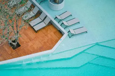 an overhead view of a pool with chairs and a tree at Tropics Kamala CTG P615 - Corner 1 BR Apt Mountain view in Kamala Beach