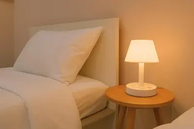 a bed with a pillow and a lamp on a table at Dalbit Heaven #Patong Beach 3 min walk Super Private House 2BR in Patong Beach