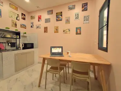 a kitchen with a wooden table with a laptop on it at Dalbit Heaven #Patong Beach 3 min walk Super Private House 2BR in Patong Beach