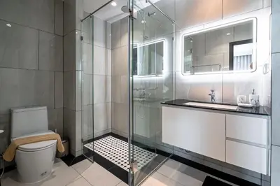 a bathroom with a shower and a toilet and a sink at The Title Legendary Bangtao by Beringela in Bang Tao Beach