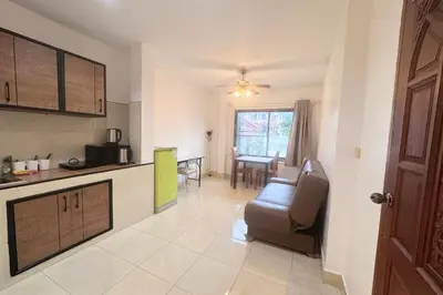 a kitchen and living room with a couch and a table at P&I Group Karon Beach Room-1 in Karon Beach